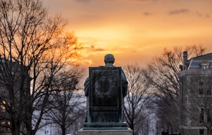 AD White watches the sun set over the Arts Quad